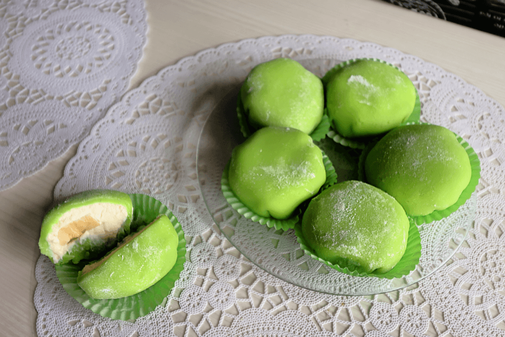 A plate of green tea rice cakes filled with cream.