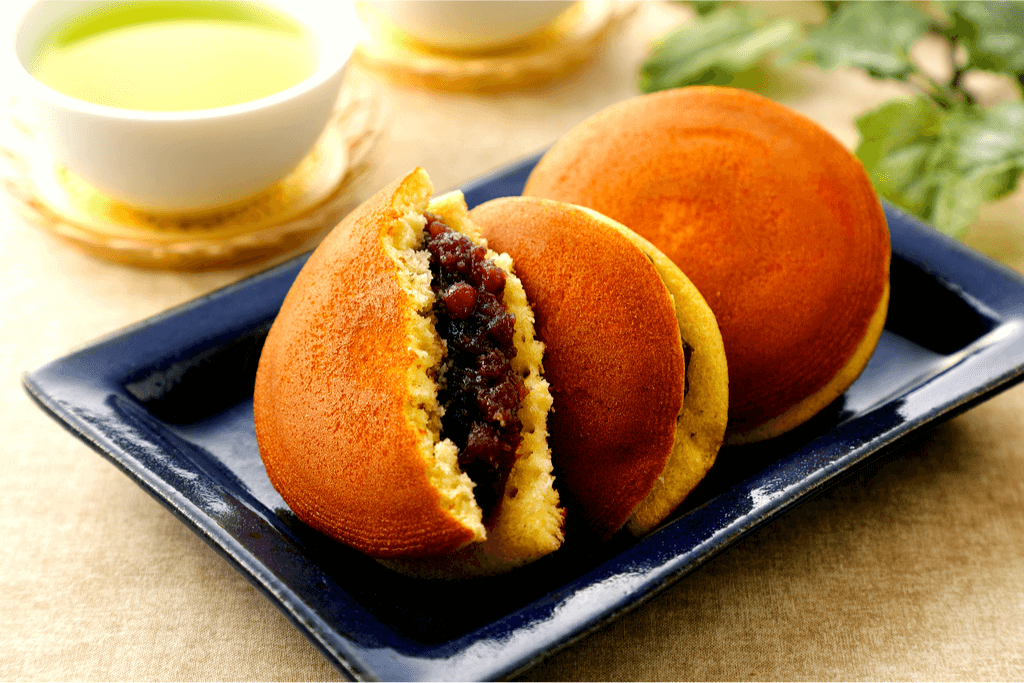 A black plate for traditional castella pancake sandwiches with red bean paste.