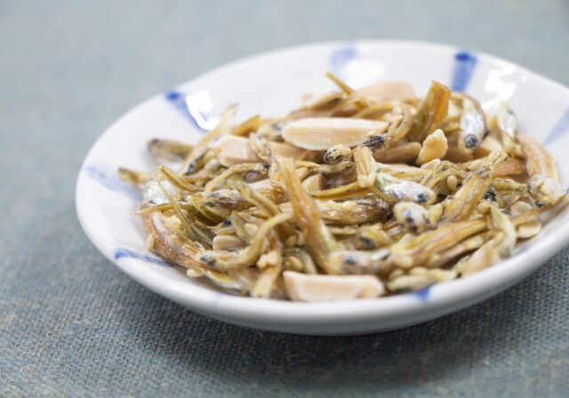 A dish full of dried sardines - a traditional and healthy Japanese snack. 