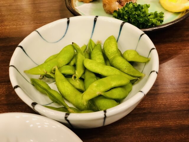 A dish full of steamed edamame beans, a healthy Japanese snack.
