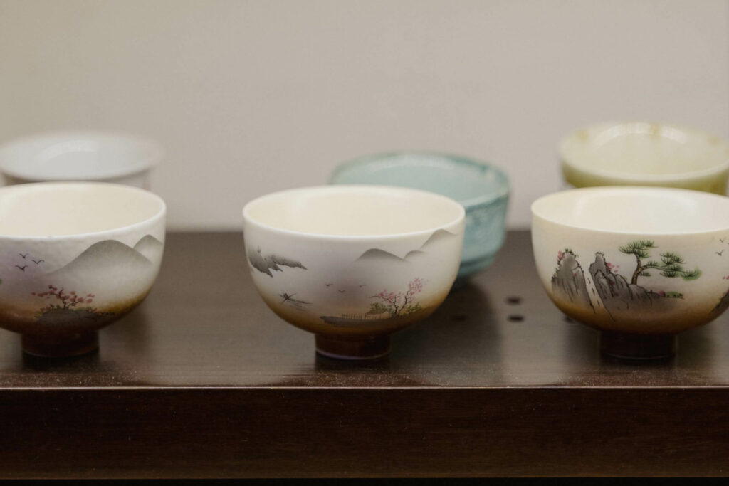A variety of Japanese ceramics on a wooden table.