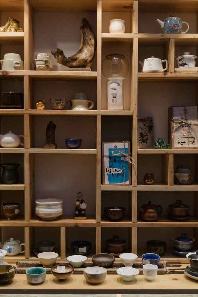 A shelf full of Japanese ceramics.