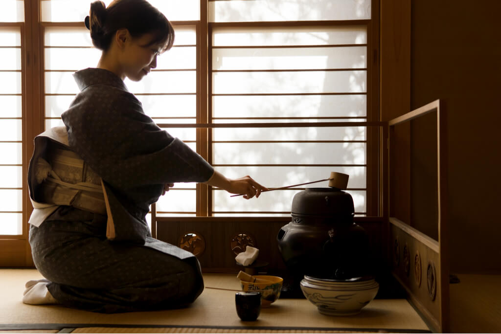 A woman preparing a Japanese tea ceremony.