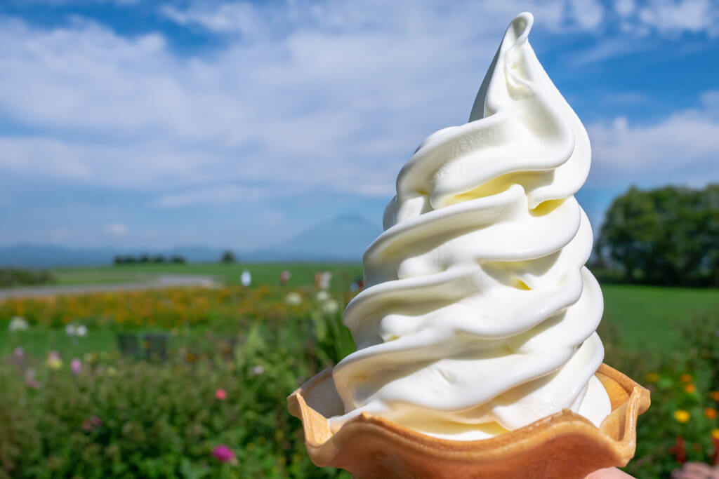 A cone full of vanilla ice cream in Hokkaido Japan. 