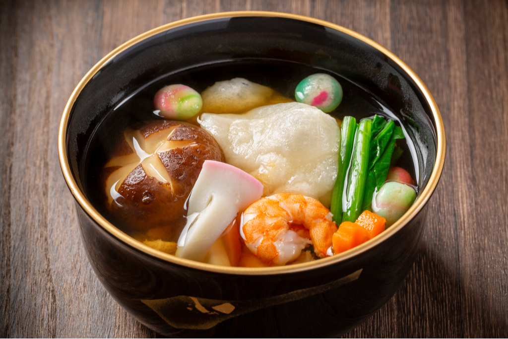 A bowl of ozoni soup, a savory dish that plays a role in mochi history.