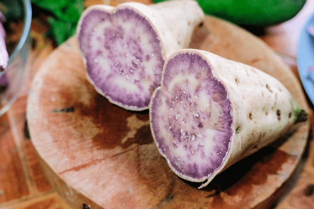 A split Hawaiian purple sweet potato.