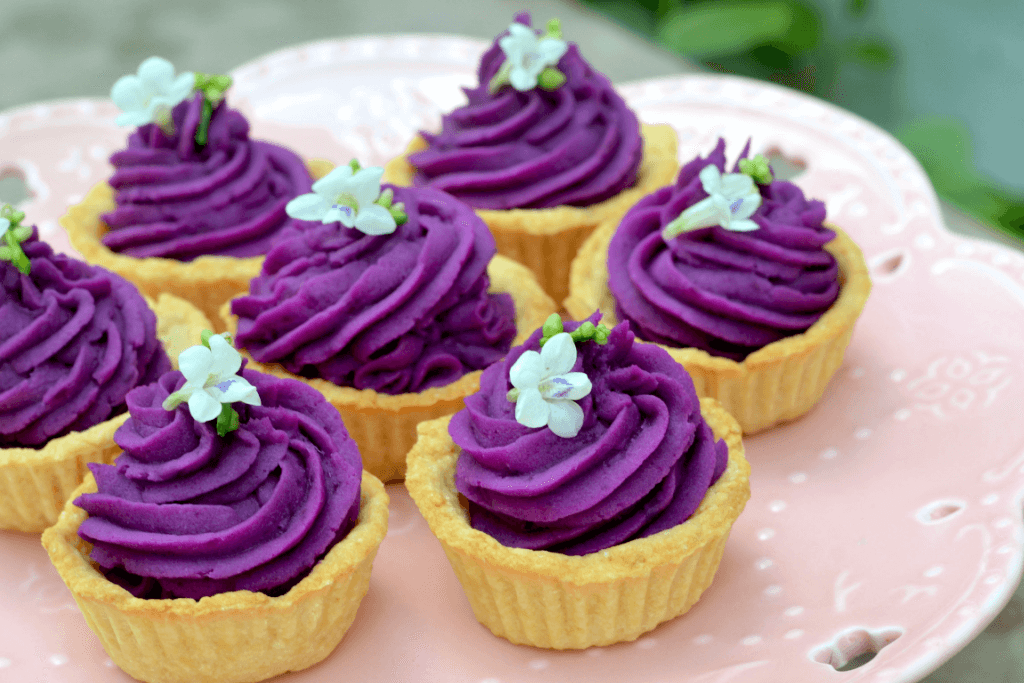 A plate of purple Okinawa sweet potato tarts, also known as beni-imo tarts.
