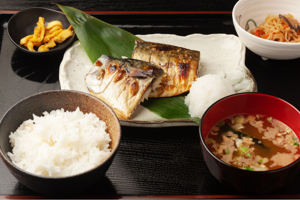 A traditional Japanese meal featuring ichiju sansai, with a balance of fish, soup and vegetables.