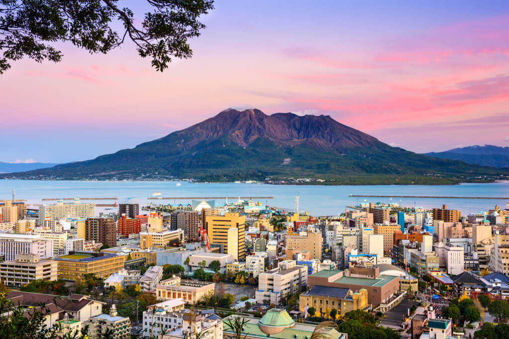 A view of a city in Kyushu with Kagoshima, an island with some of the best hiking trails in Kyushu, across the water