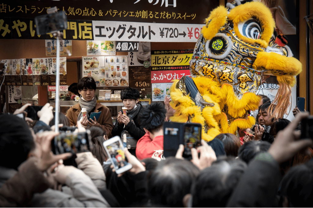 Many people take pictures and record a lion used in lion dancing at the Yokohama Chinatown Chinese New Year Celebration.