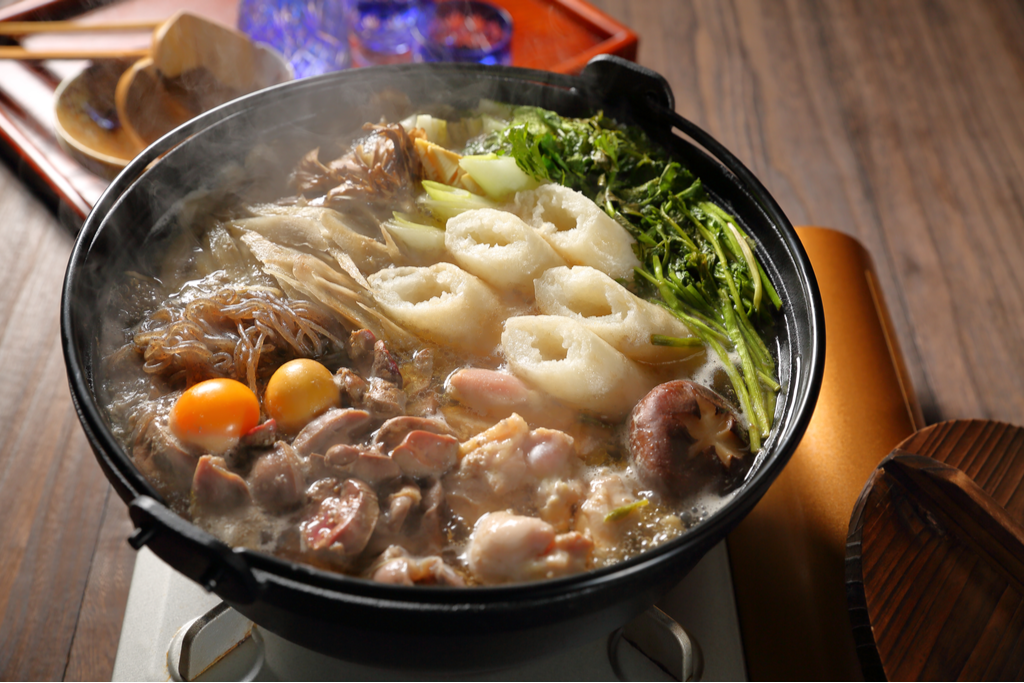 A pot of kiritanpo nabe, which is a nabemono with pounded rice cylinders inside.