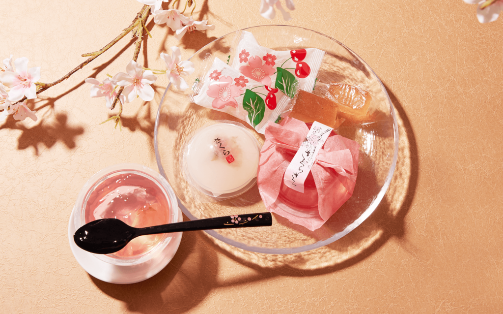A picture of Sakura-infused sweets from Sakuraco's Sakura-themed box in 2022. Everything, from the jelly to the mochi, is either white or pink.