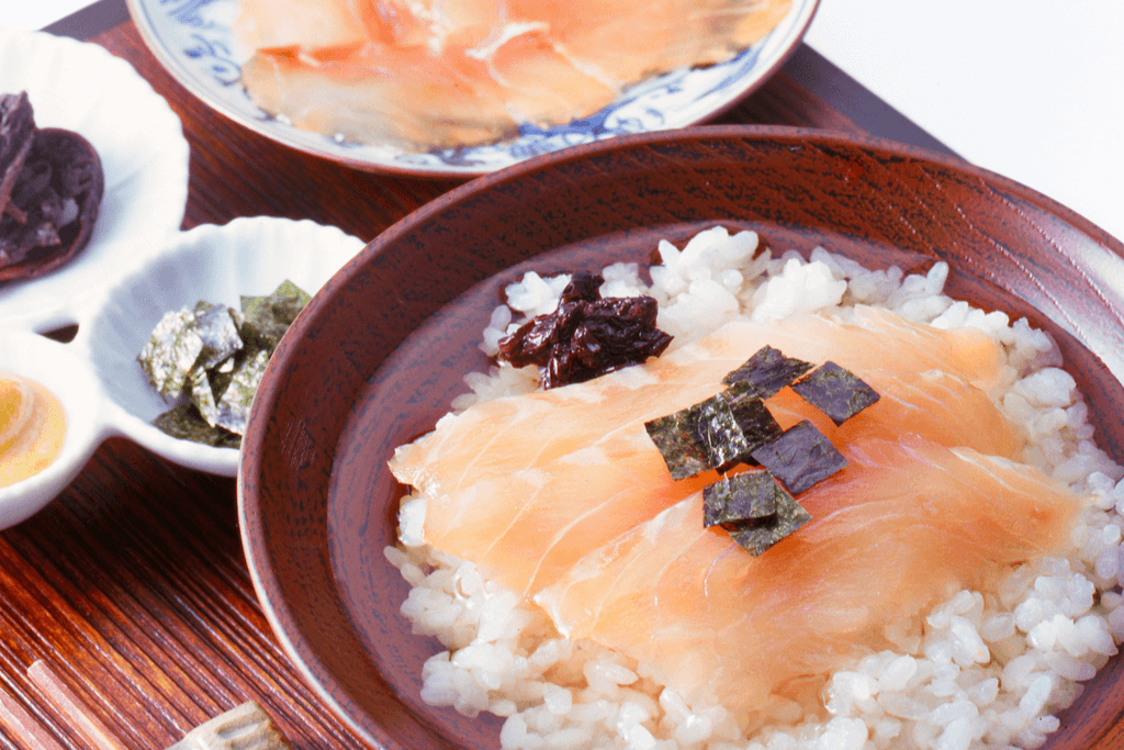 A bowl of sea bream sashimi on top of rice, made in preparation for hot rice soup.