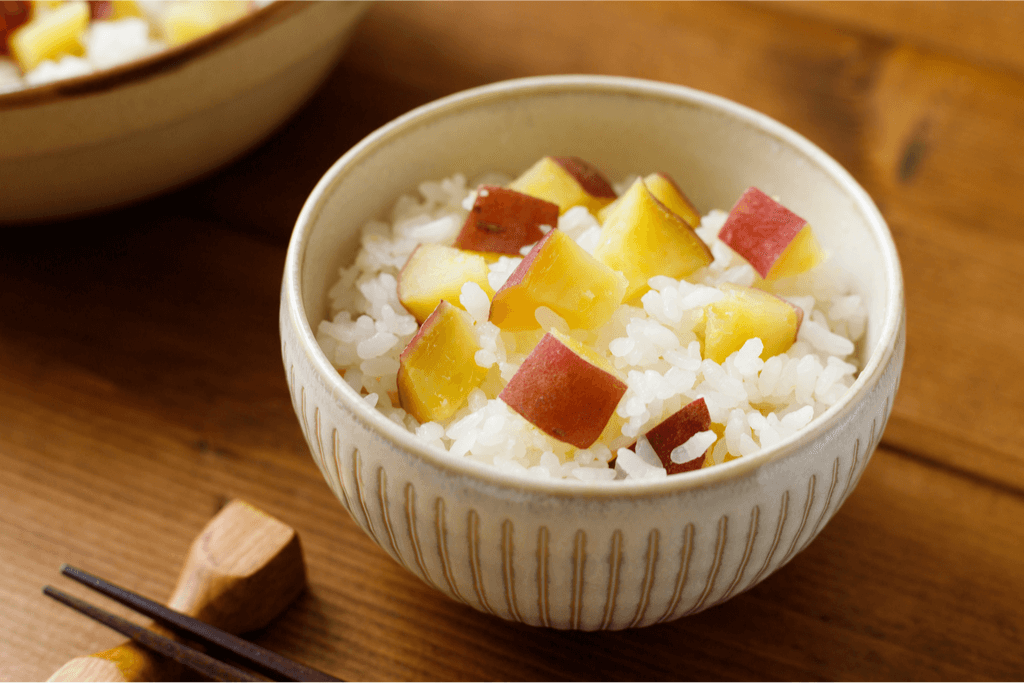 A bowl of white rice with diced sweet potato (yellow flesh, red skin), also known as satsumaimo gohan. It's one of many traditional tsukimi foods. 