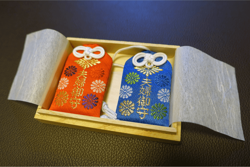 A red and blue omamori good luck charm from Japan, representing good luck for marriage.