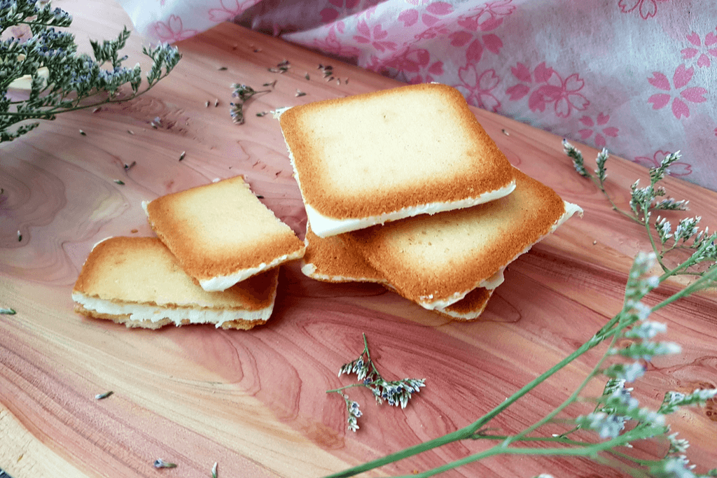 A stack of shiroi koibito, a light cookie sandwich with vanilla cream inside.