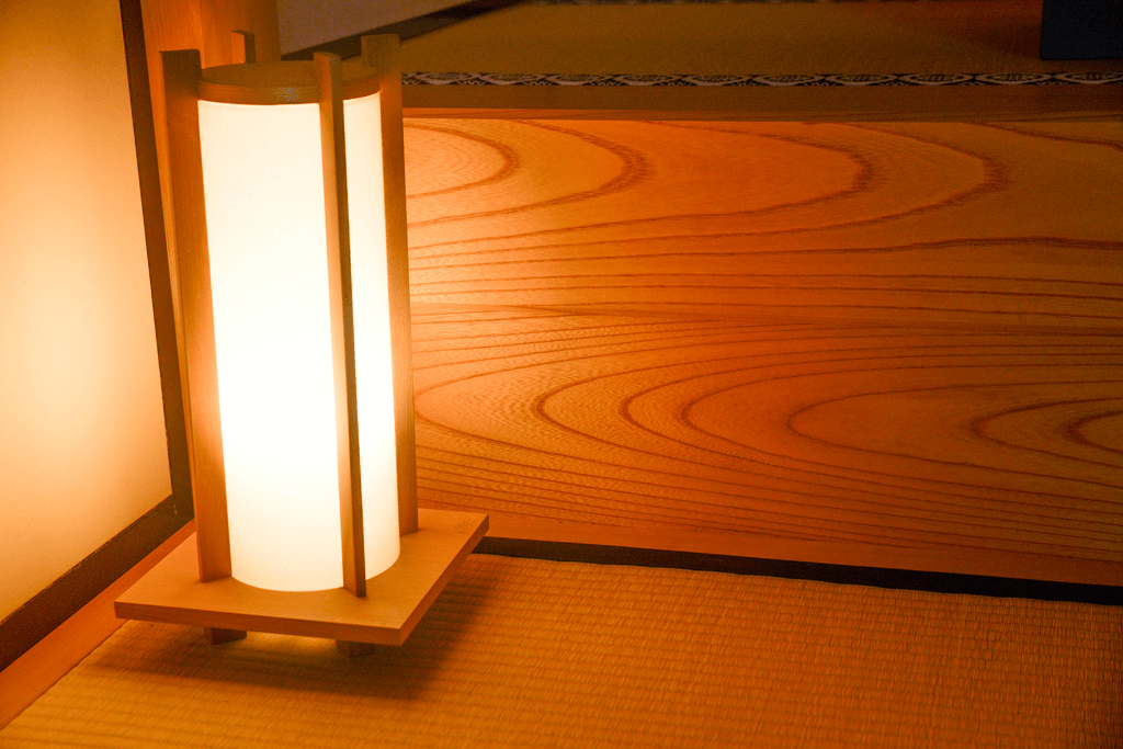 A rectangular Japanese lantern, with a warm white glow.