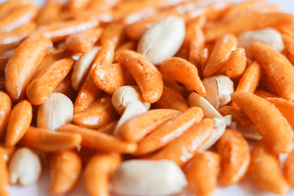 Orange, small seed-shaped crackers called kaki no tane with peanuts, a type of traditional Japanese snacks.