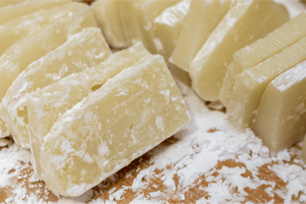 A bunch of raw slices of kirimochi, still coated in flour.