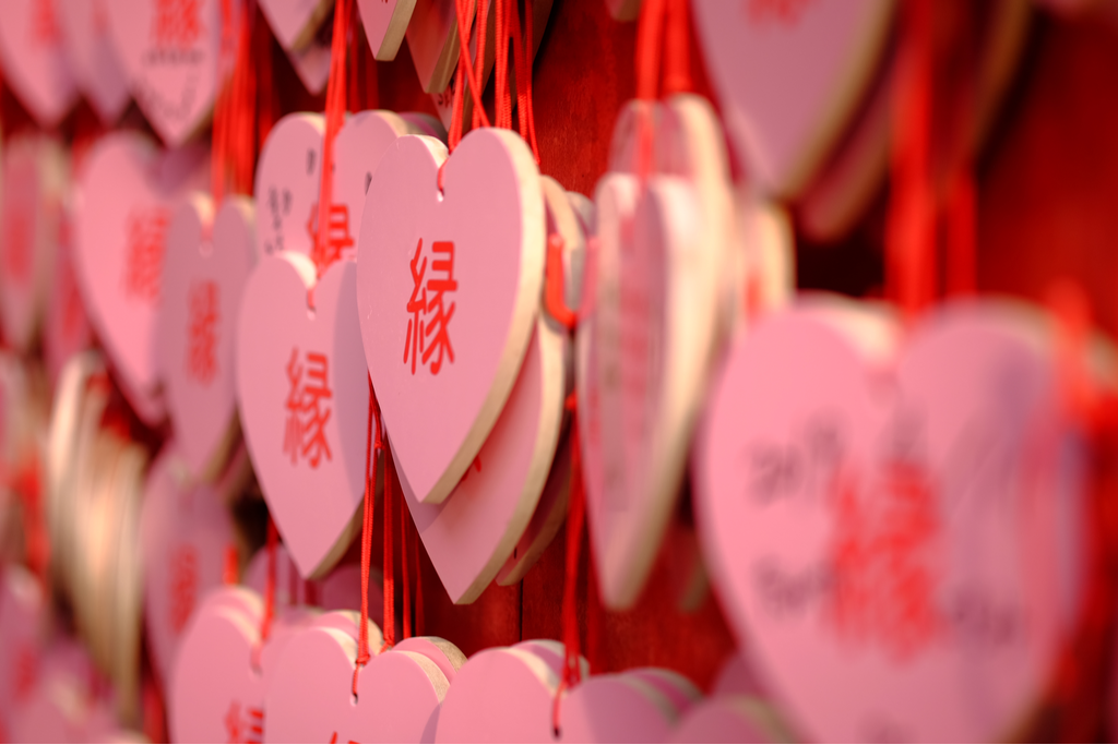 A photograph of pink, heart shaped charms you usually see at a Shinto shrine. Not exactly a place on Valentines Day in Japan where you would give giri and honmei choco.