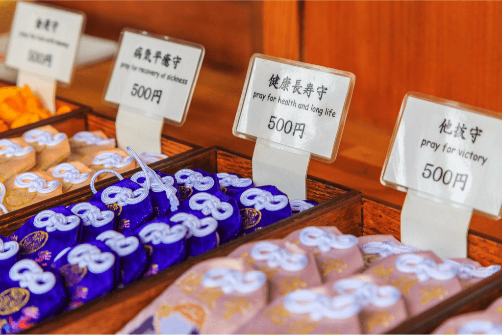 A rack of different kiinds of  omamori for sale.