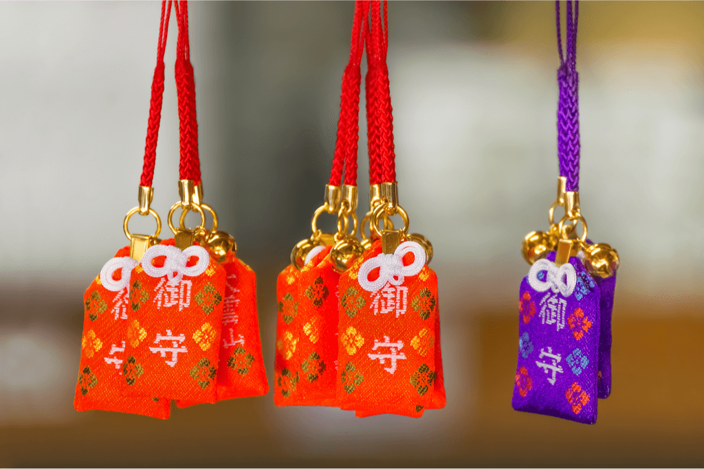 An assortment of red and blue Japanese good luck charms.