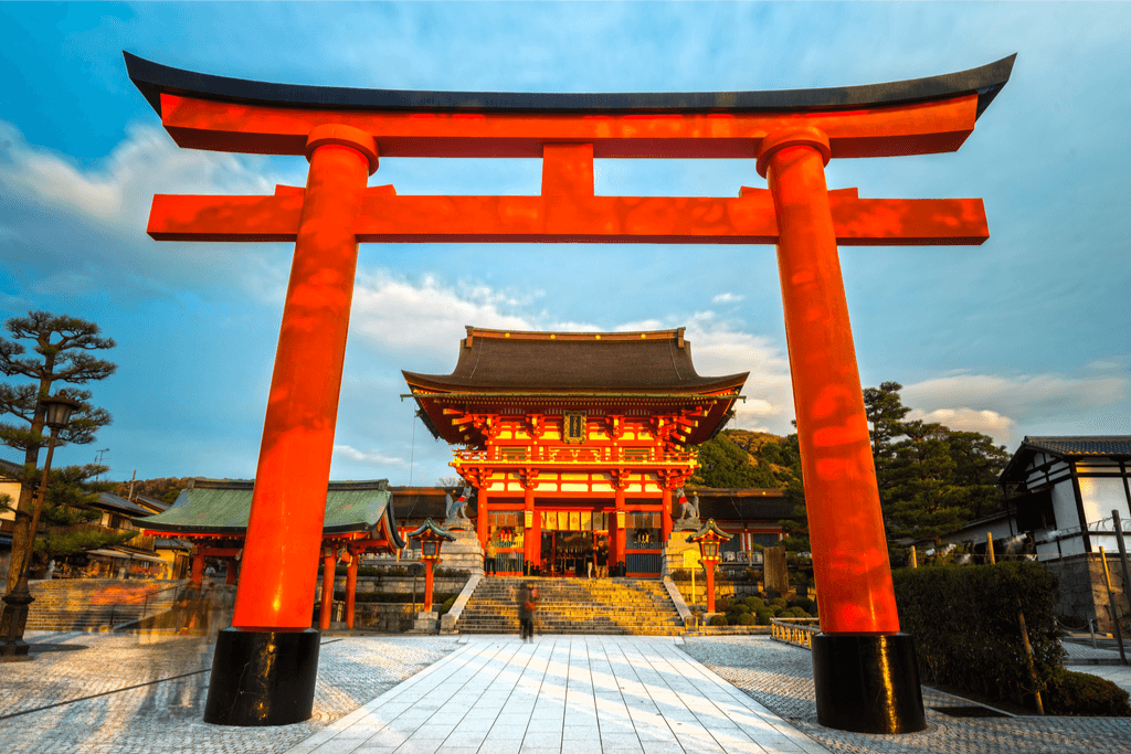 An imposing red gate torii gate, reflective of shinto in Japan.