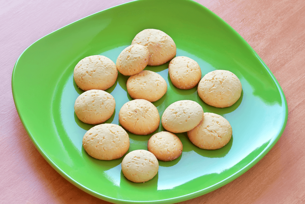 A plate of round and beige tamago boro cookies, one of many traditional Japanese snacks to enjoy.