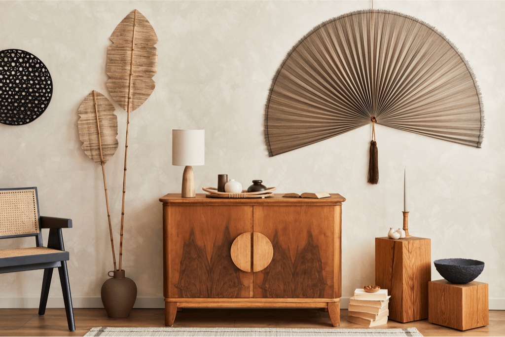A neutral-colored room of Japanese home decor, which includes a large folding fan.