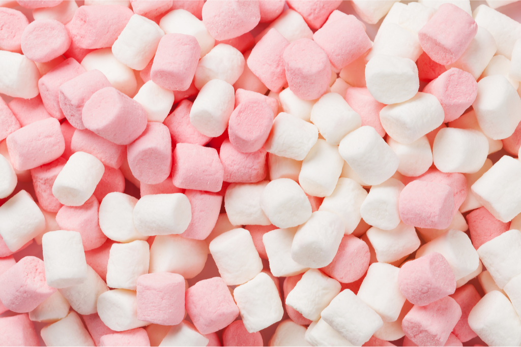 A photograph of small pink and white marshmallows.