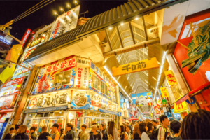 Exterior shot of a shopping district in Osaka lit up in yellow celebrate Golden Week in Japan.