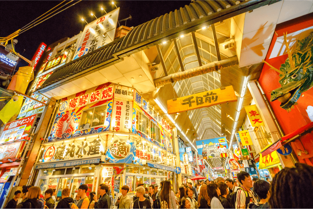 Exterior shot of a shopping district in Osaka lit up in yellow celebrate Golden Week in Japan.