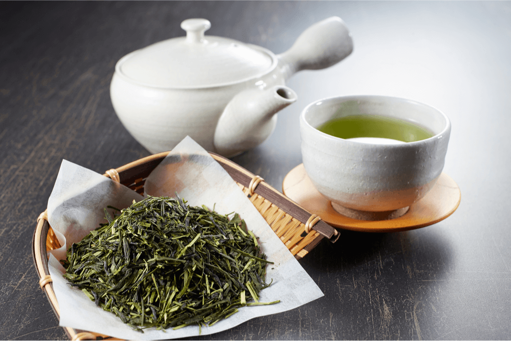 A tea pot, along with a bowl of sencha, and sencha tea.