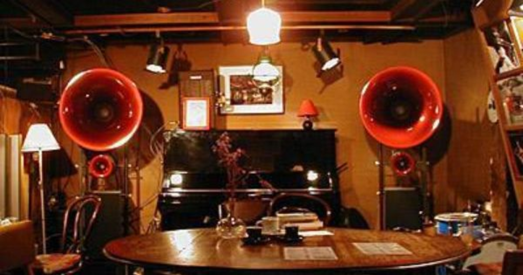 An underground Yokohama jazz club with red loudspeakers.