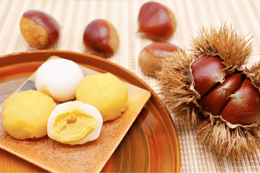 A plate of dango filled with chestnut paste, along with some chestnuts on the side. Chestnuts are popular in Ibaraki.