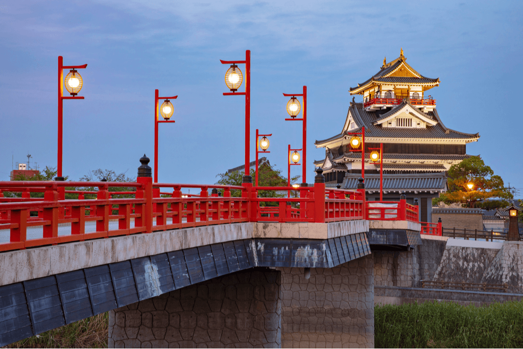 A castle and a red bridge in Aichi Prefecture.