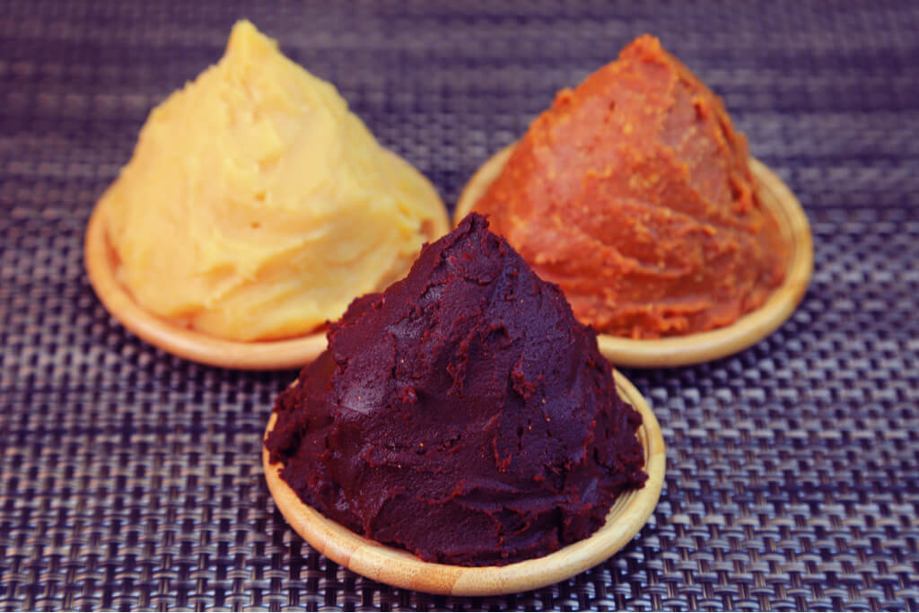 Plates of red, yellow and white miso paste. Each plate is piled high, like domes. Miso is very popular in aichi Prefecture.