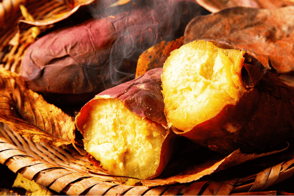 A picture of baked sweet potato, or yakiimo. It has dark red skin and yellow flesh.