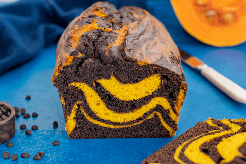 A loaf of brown and orange marble pumpkin bread.