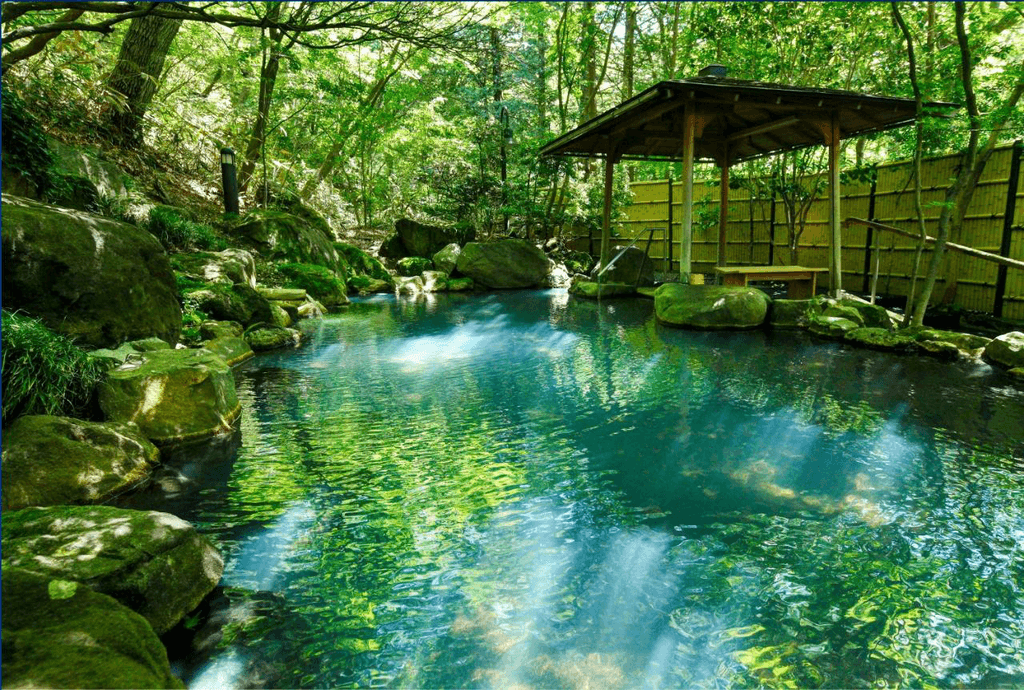 A shot of Nasu Onsen. It's surrounded by green forests and is a shade of blue. One of many hot springs that would look nice in the winter.