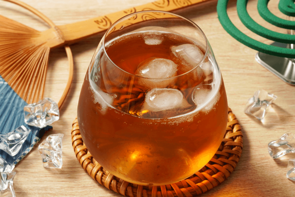 A glass of barley tea with ice cubes.