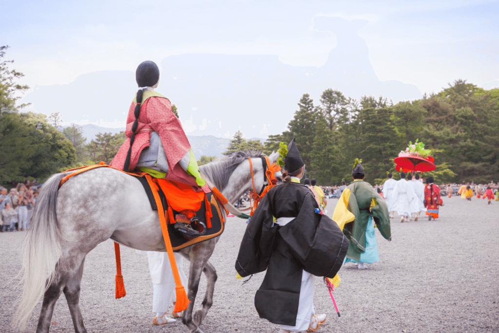 A reenactment of Heian-era people. The princess in an elaborate junihitoe kimono on horseback, with a man dressed in a formal kimono by her side.