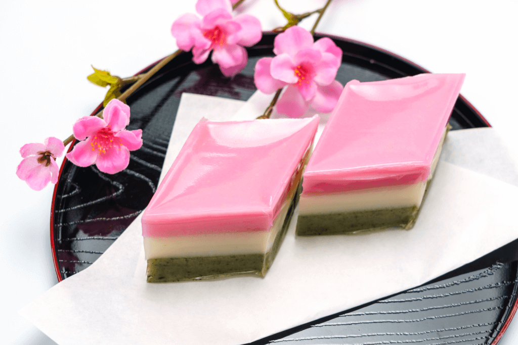 A plate of hishi mochi, a stacked rice cake of pink, white and green. This is a very common treat for Girls Day.