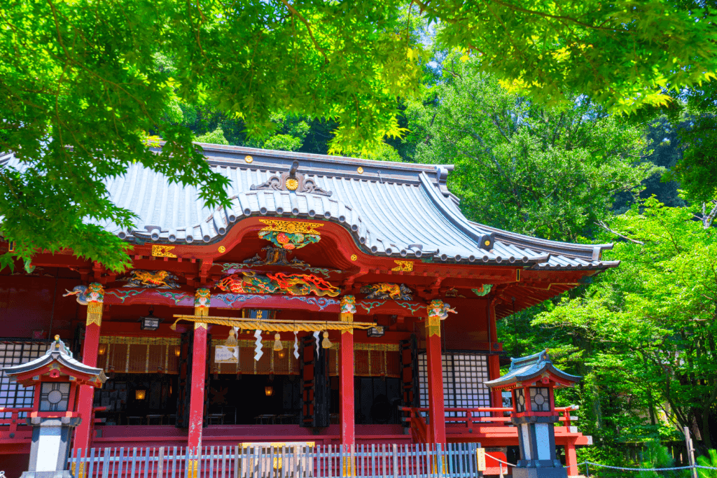 What is a temple of love? Exterior shot of Izusan Shrine, a traditional Shinto shrine that's very red.