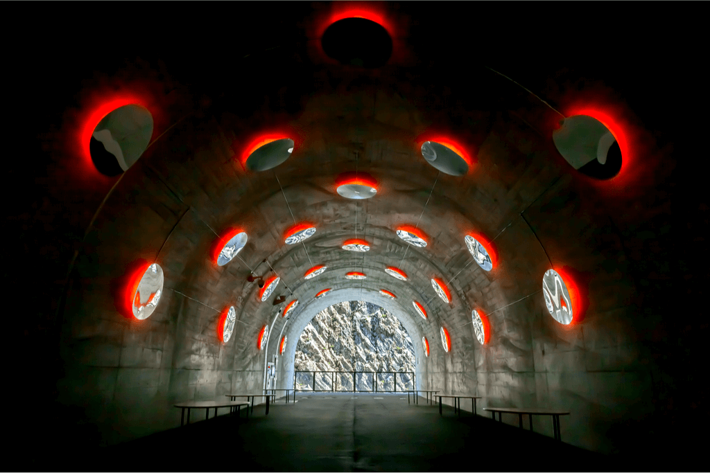A tunnel in Kiyotsu Gorge with illuminated red holes in the wall.