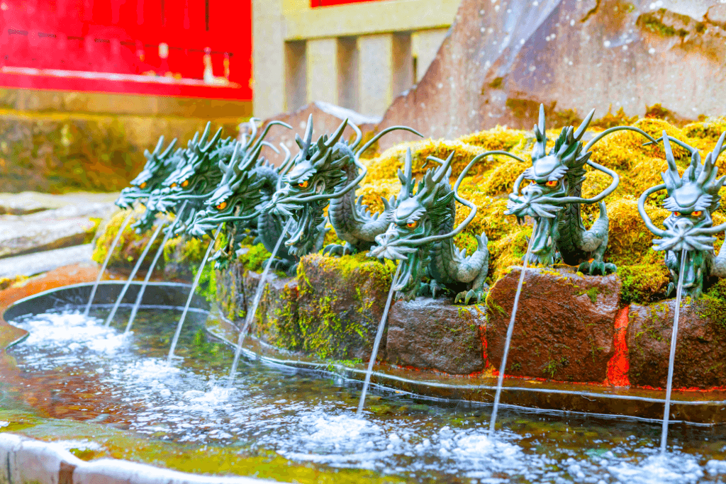 A row of ryujin fountains at a shrine. They are mythical creatures of Japan.