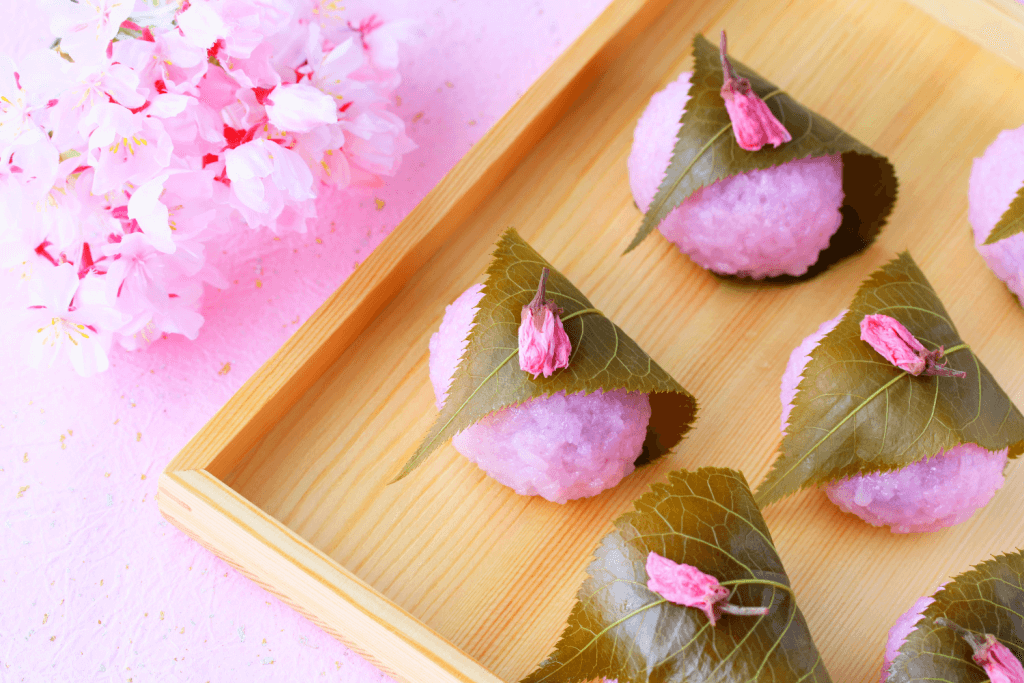A platter of pink sakura mochi wrapped in pickled perilla leaves. It's a spring in Japan delicacy.