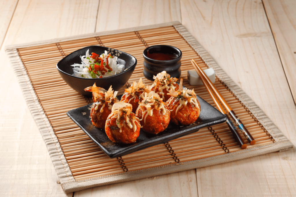 A plate of takoyaki (octopus balls) on a delicious platter.