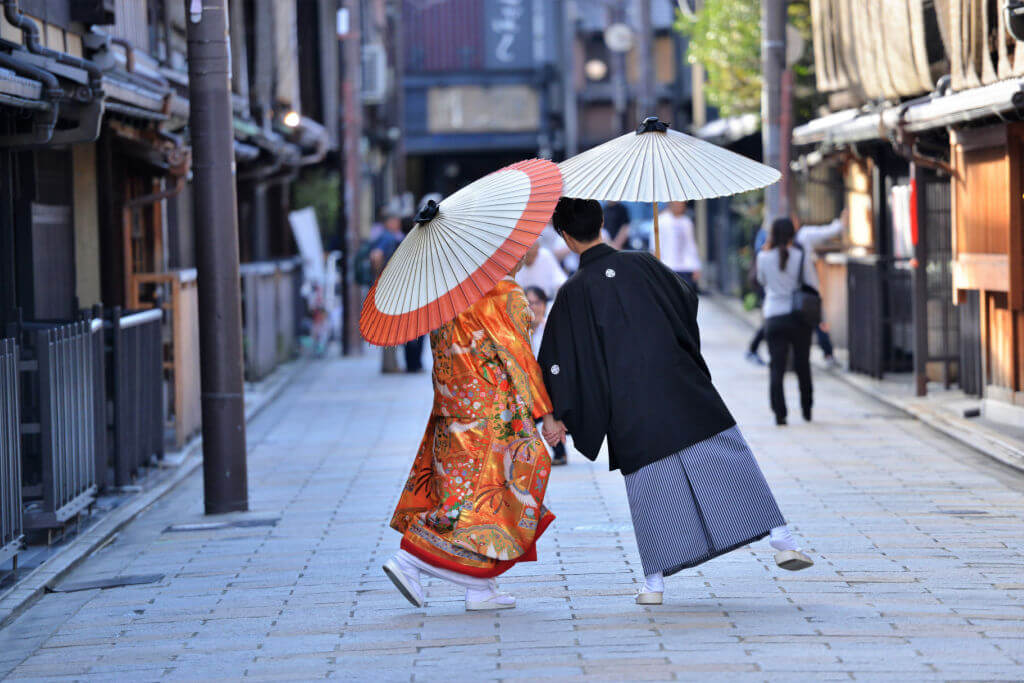 Japanese couple in traditional kimono taking pictures in Japan