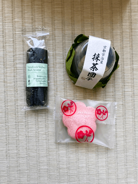 Three snacks, black sesame yatsuhashi, Uji green tea and plum senbei.